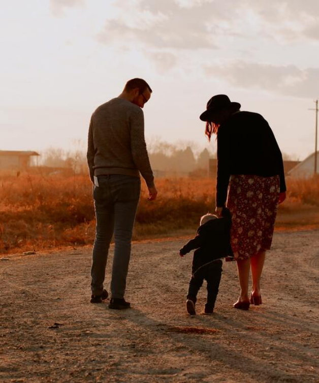 man-and-woman-walking-with-there-kid-on-dirt-road-3285036